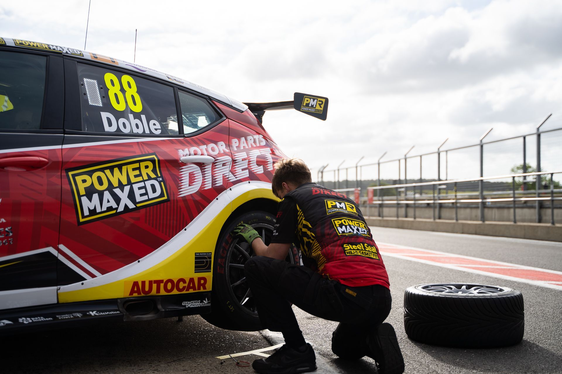PMR Mechanic working on Mikey Doble's Back Left Tyre at Snetterton