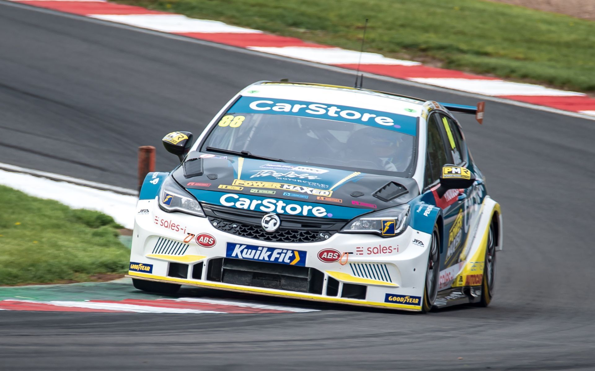 A race car is driving down a race track.