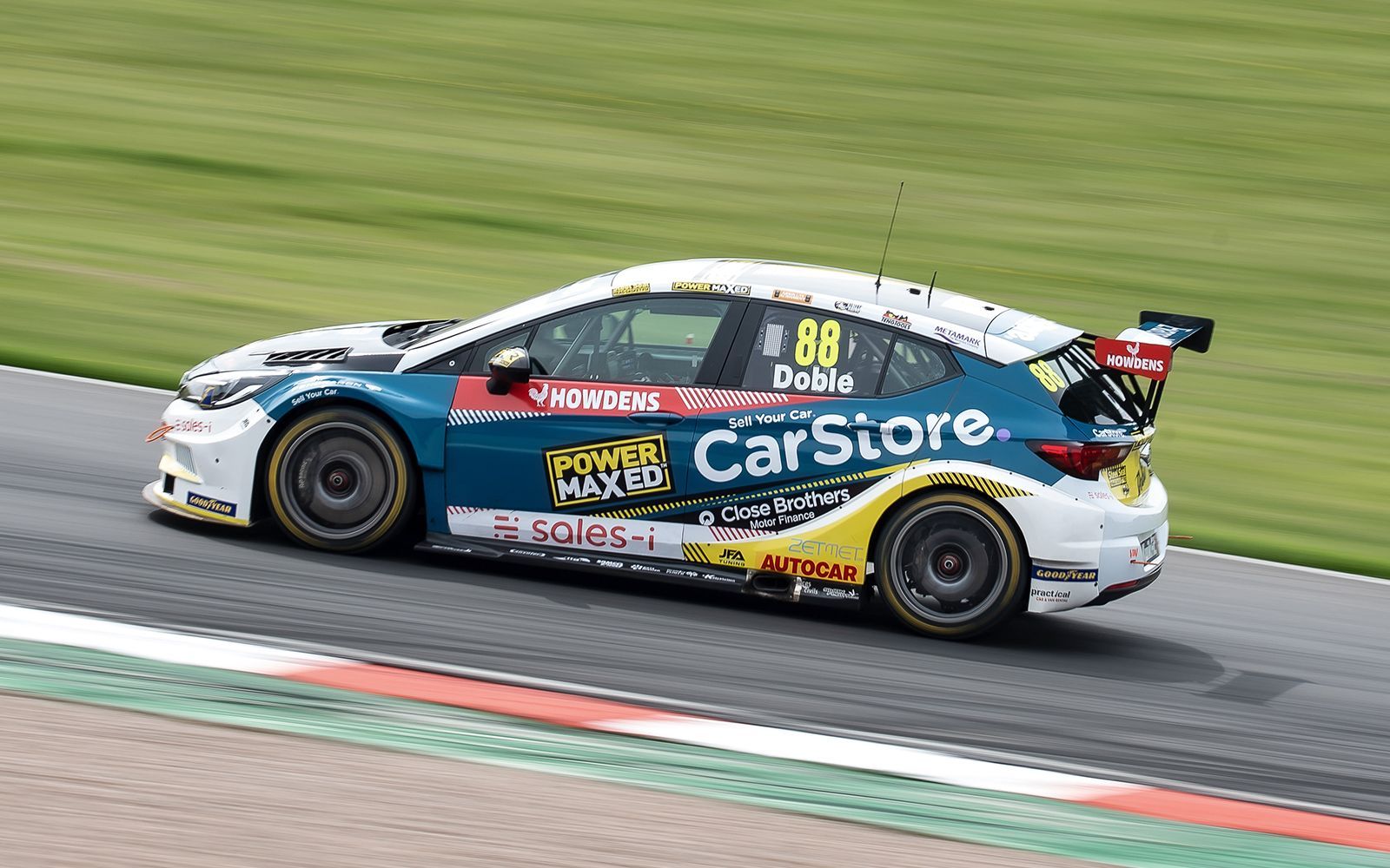 A race car is driving down a race track.