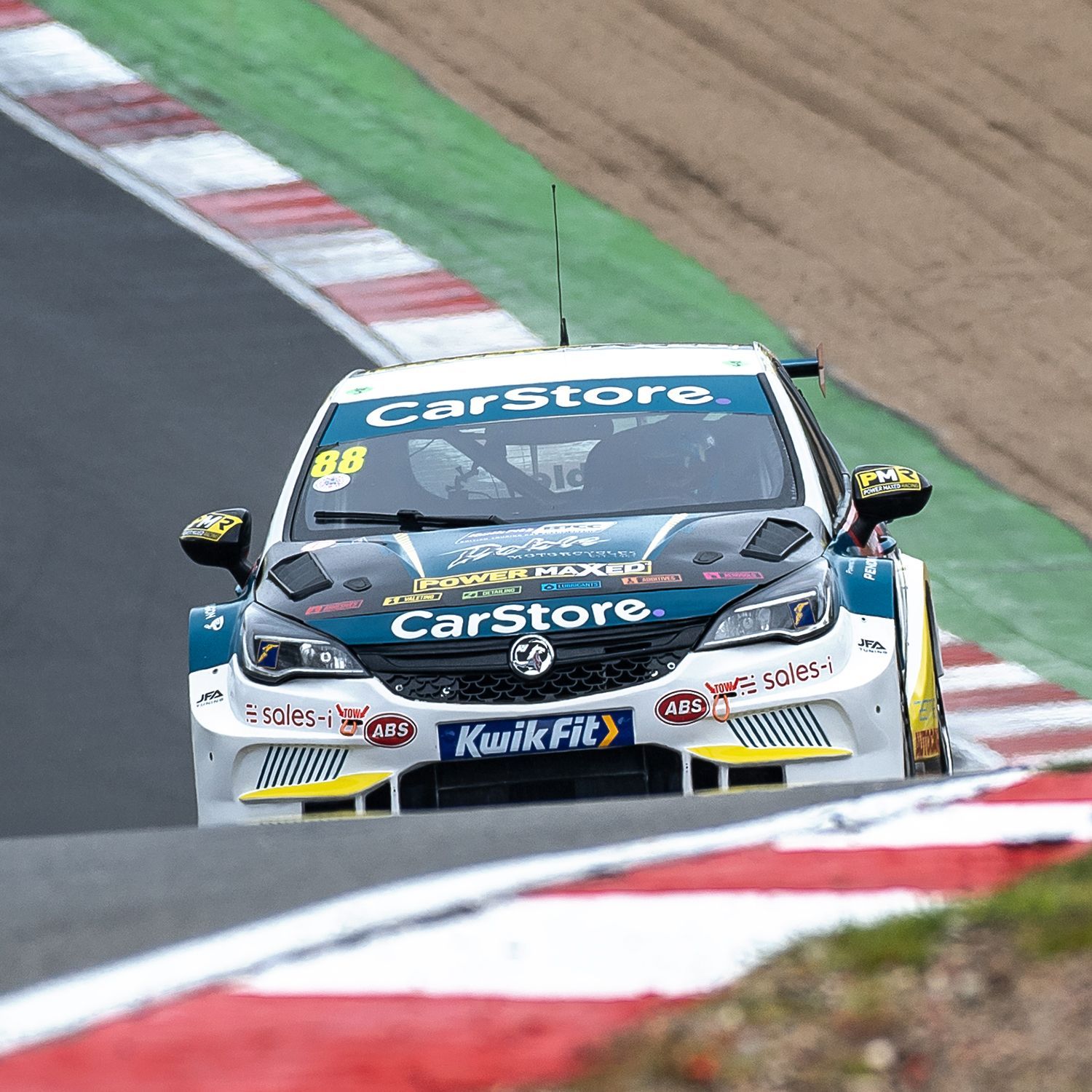 A race car is driving down a race track.