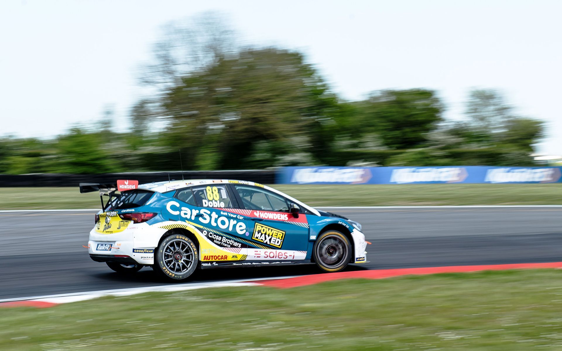 A race car is driving down a race track.