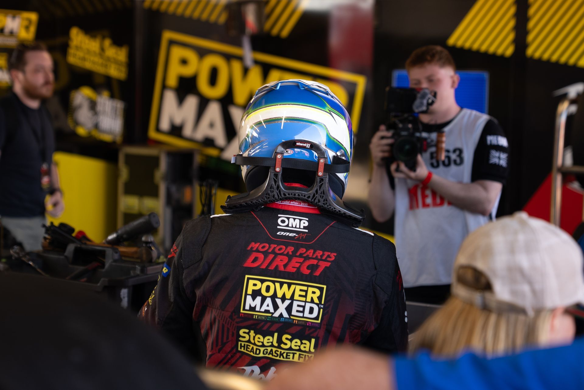 A man is taking a picture of a man wearing a helmet.