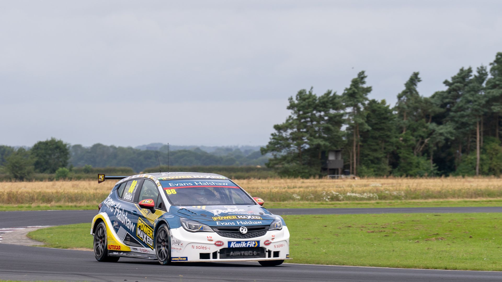 A race car is driving down a race track.
