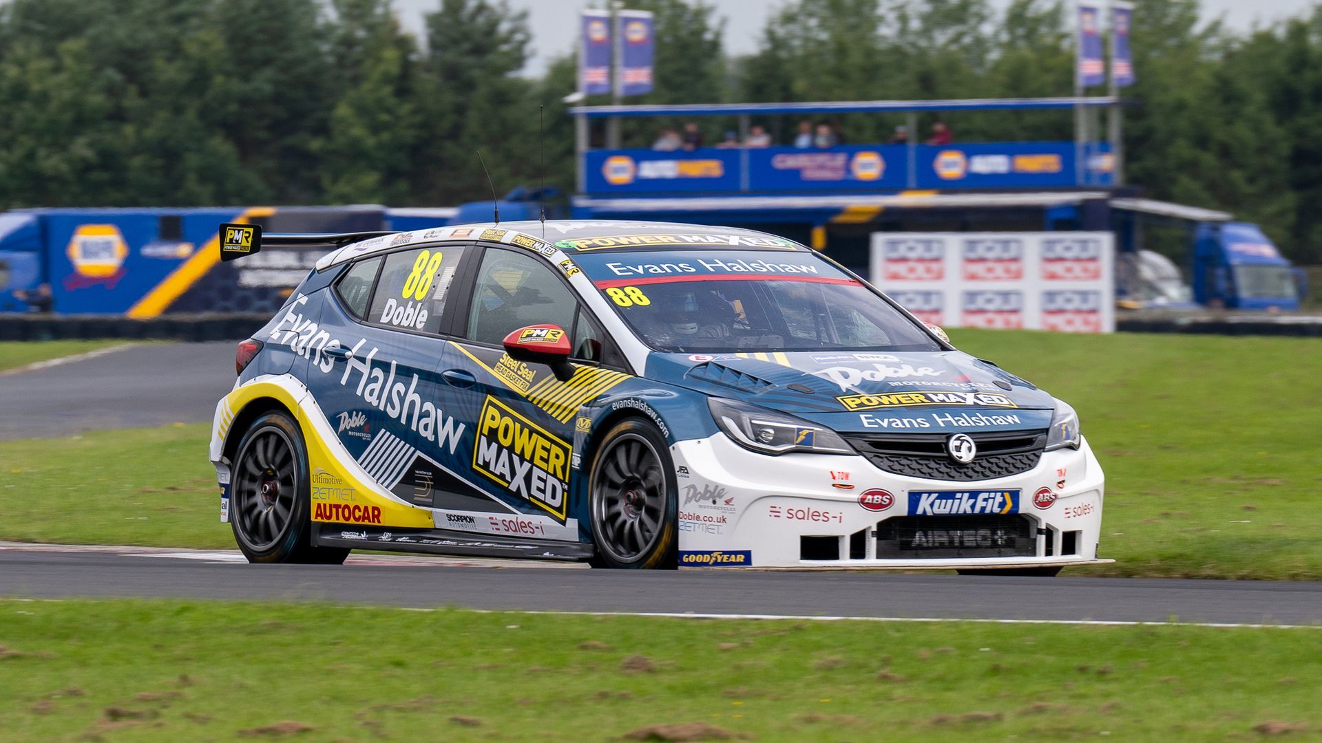 A race car is driving down a race track.
