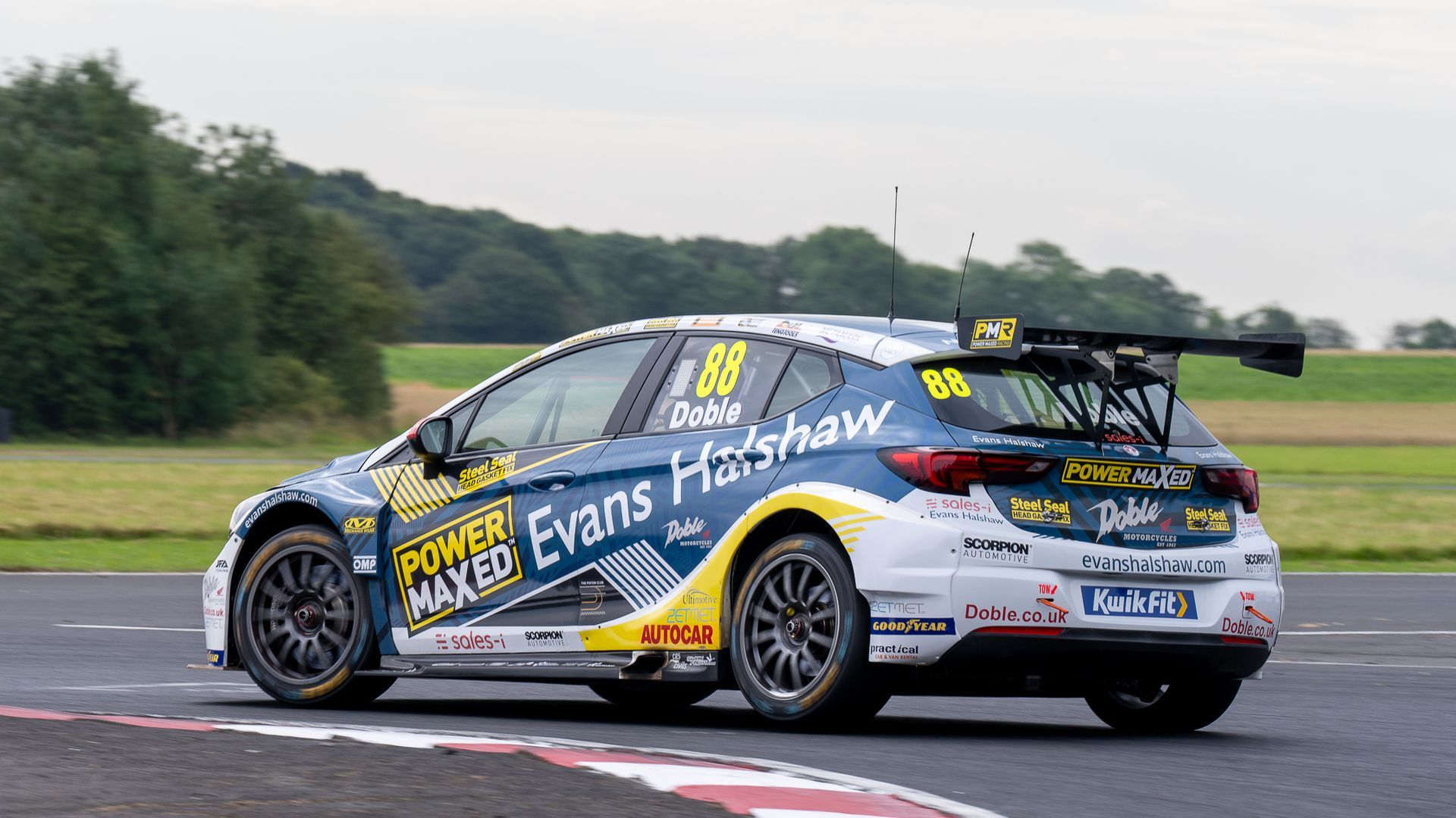 A race car is driving on a race track.