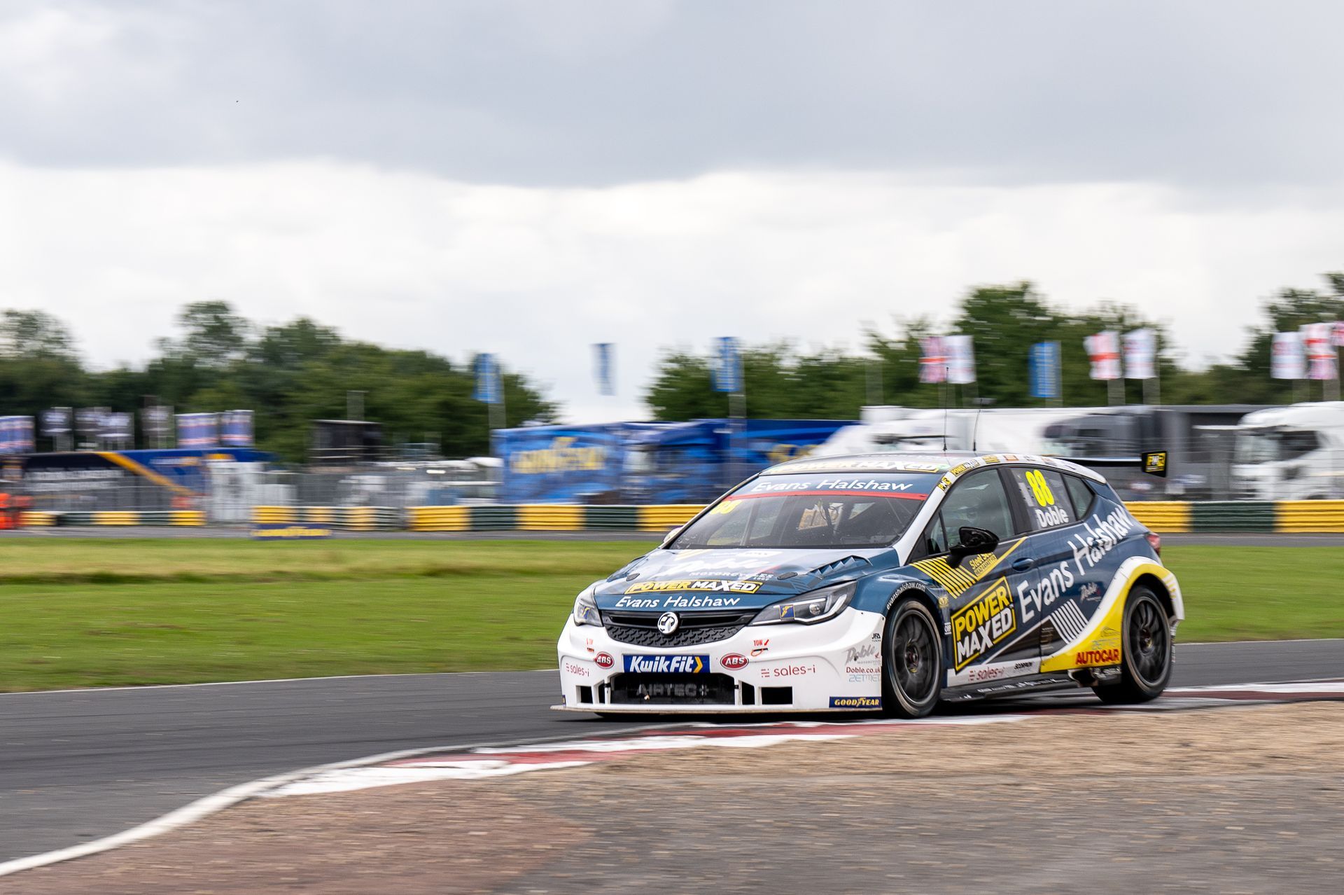 A race car is driving down a race track.