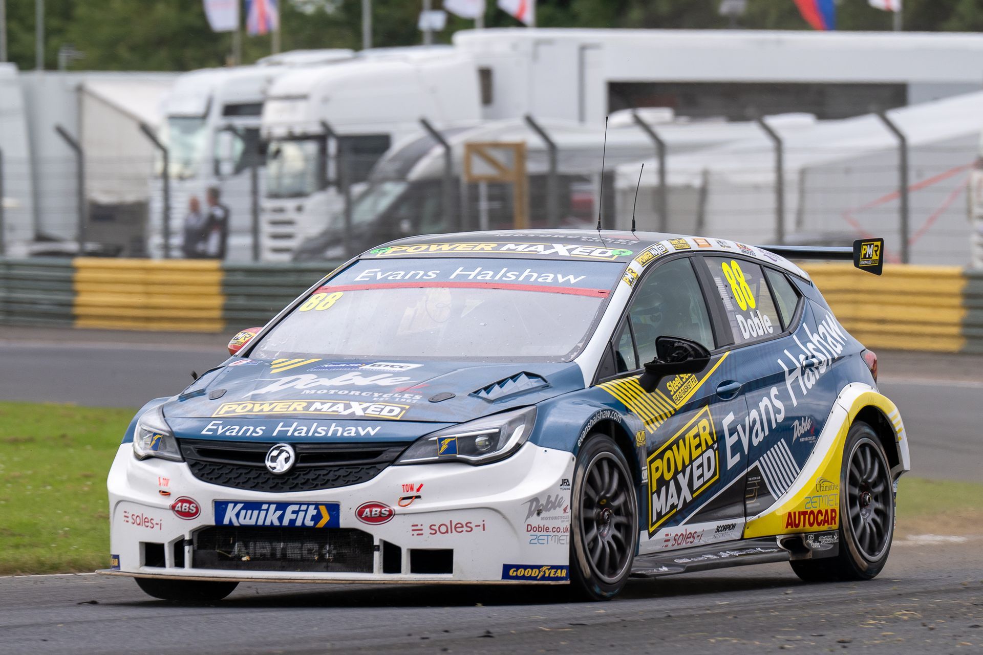 A racing car is driving on a race track.