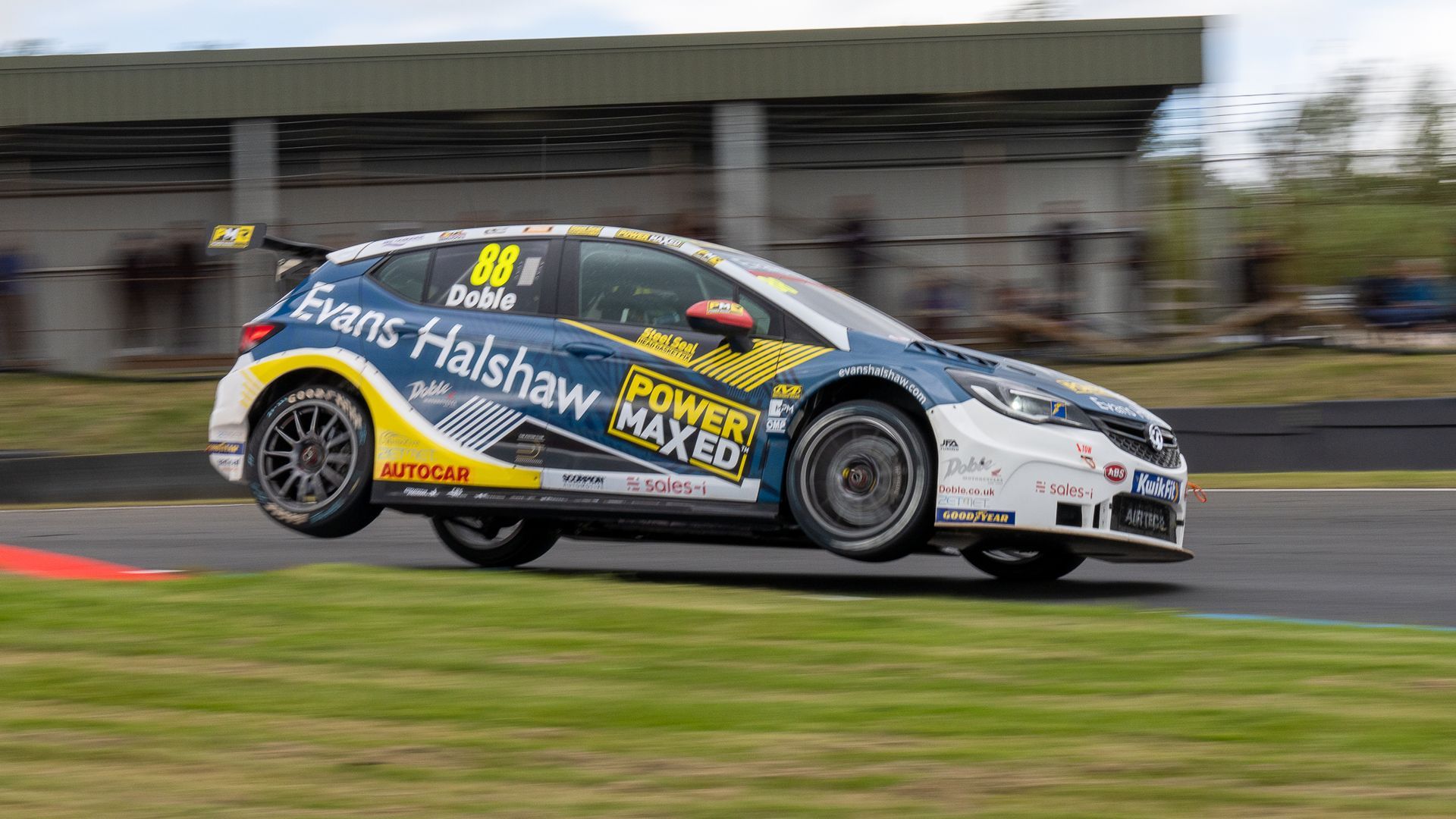 A race car is driving down a race track.