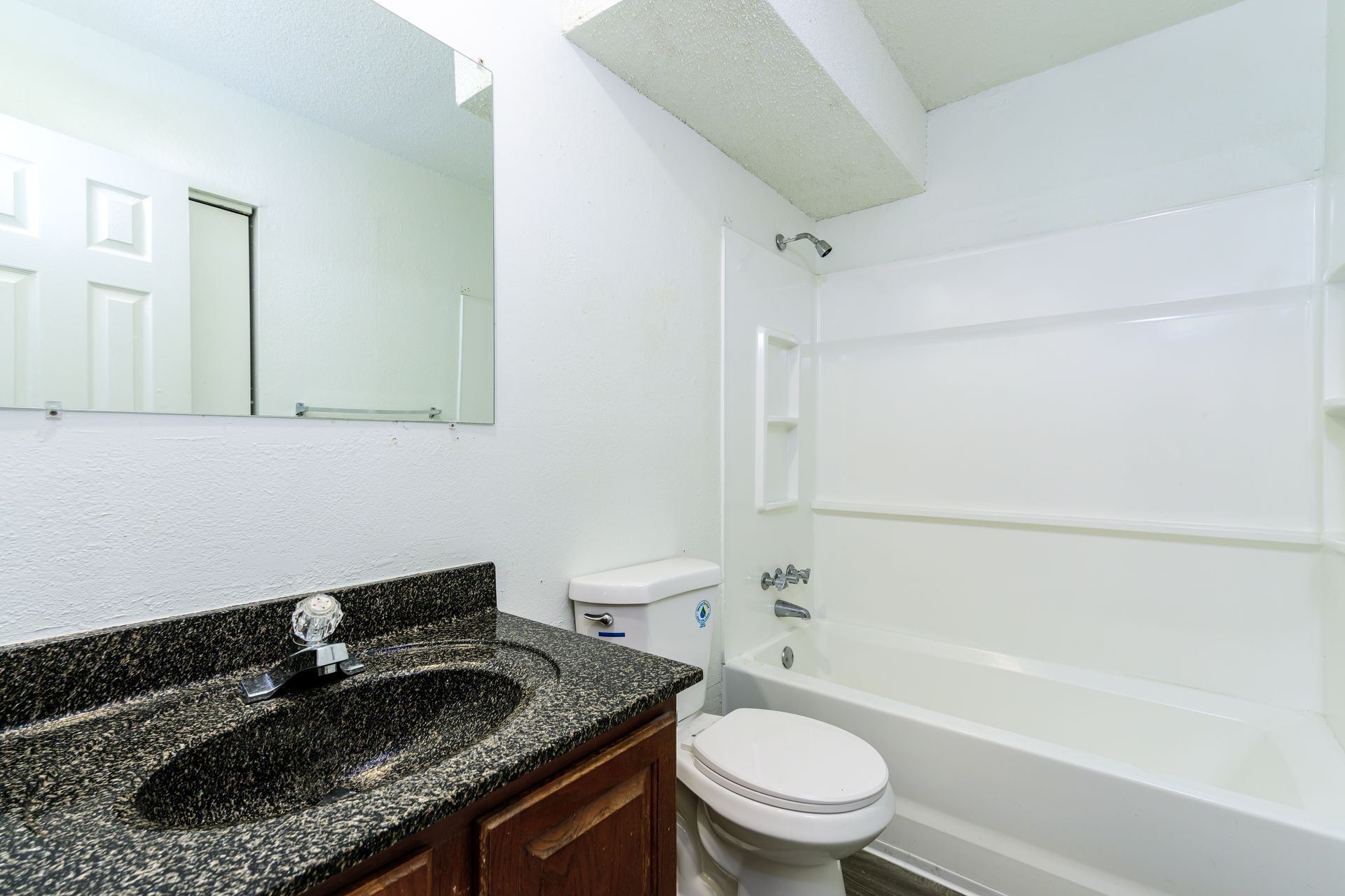 A bathroom with a toilet , sink , and bathtub.