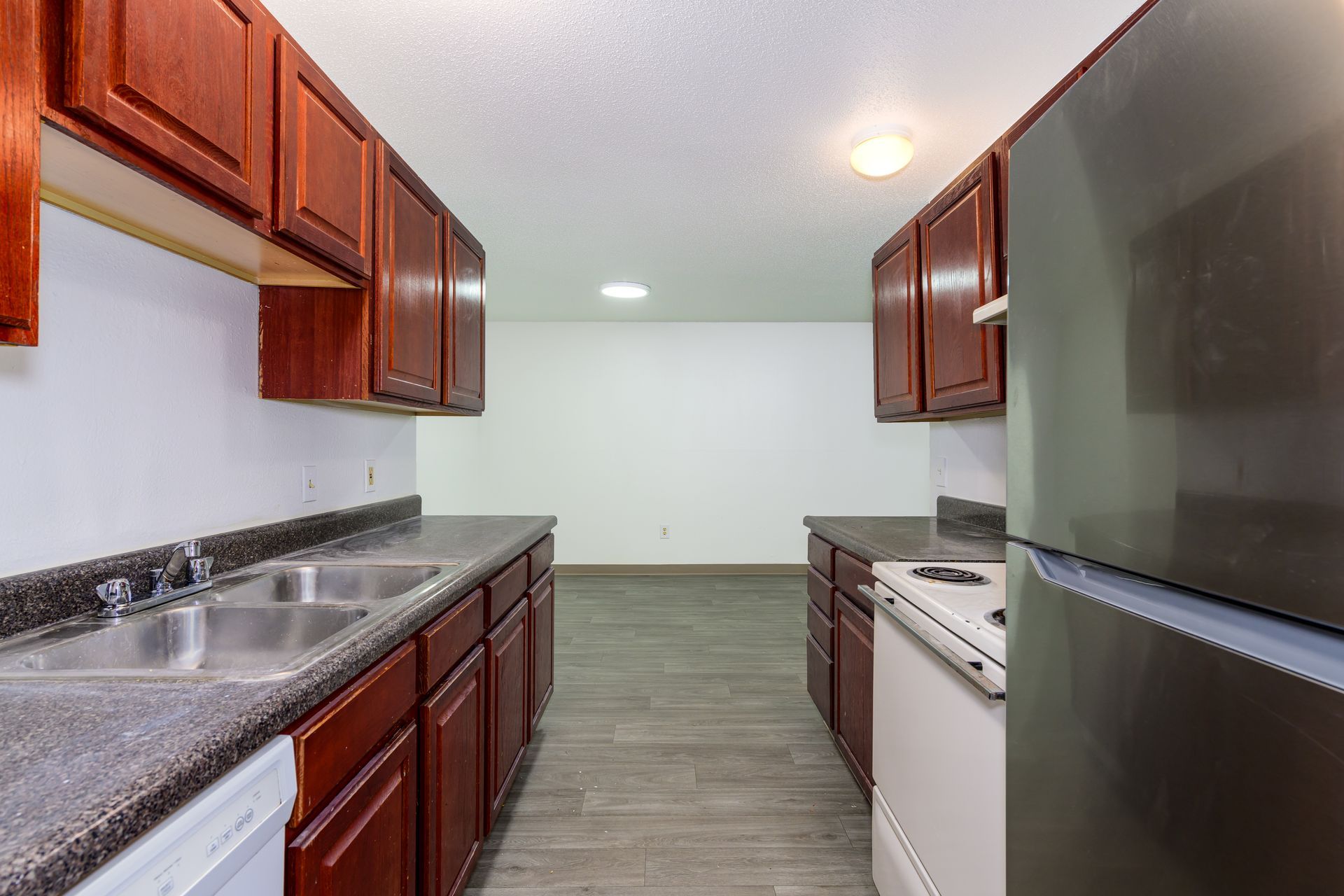 A kitchen with stainless steel appliances and wooden cabinets
