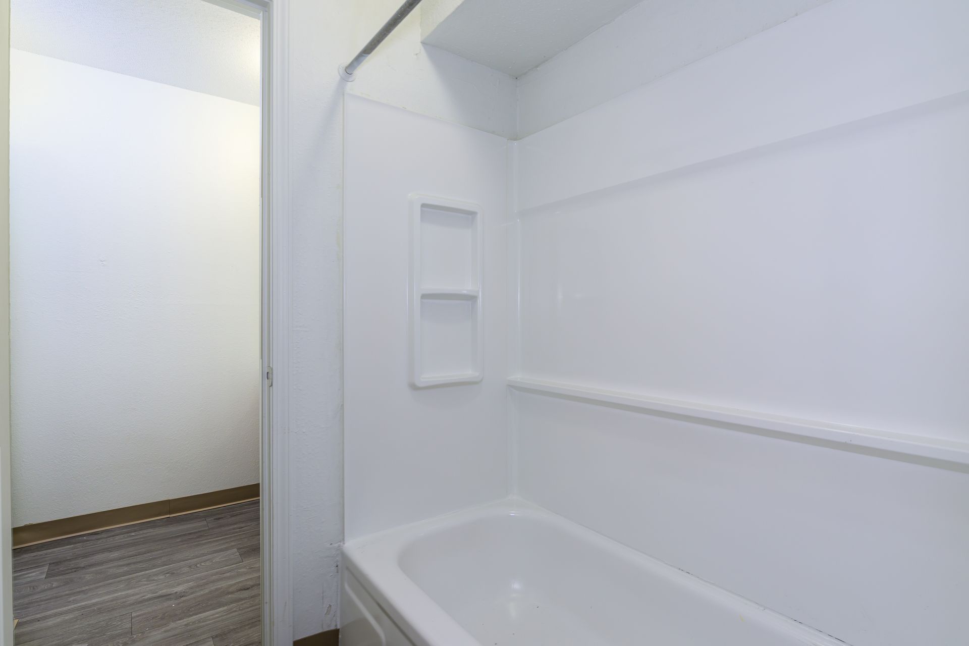 A bathroom with a bathtub and a shower stall.