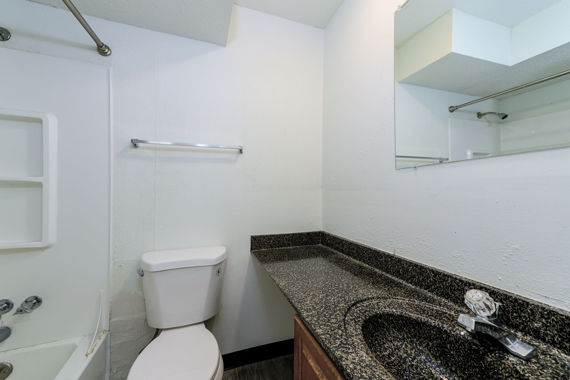 A bathroom with a toilet , sink and bathtub.