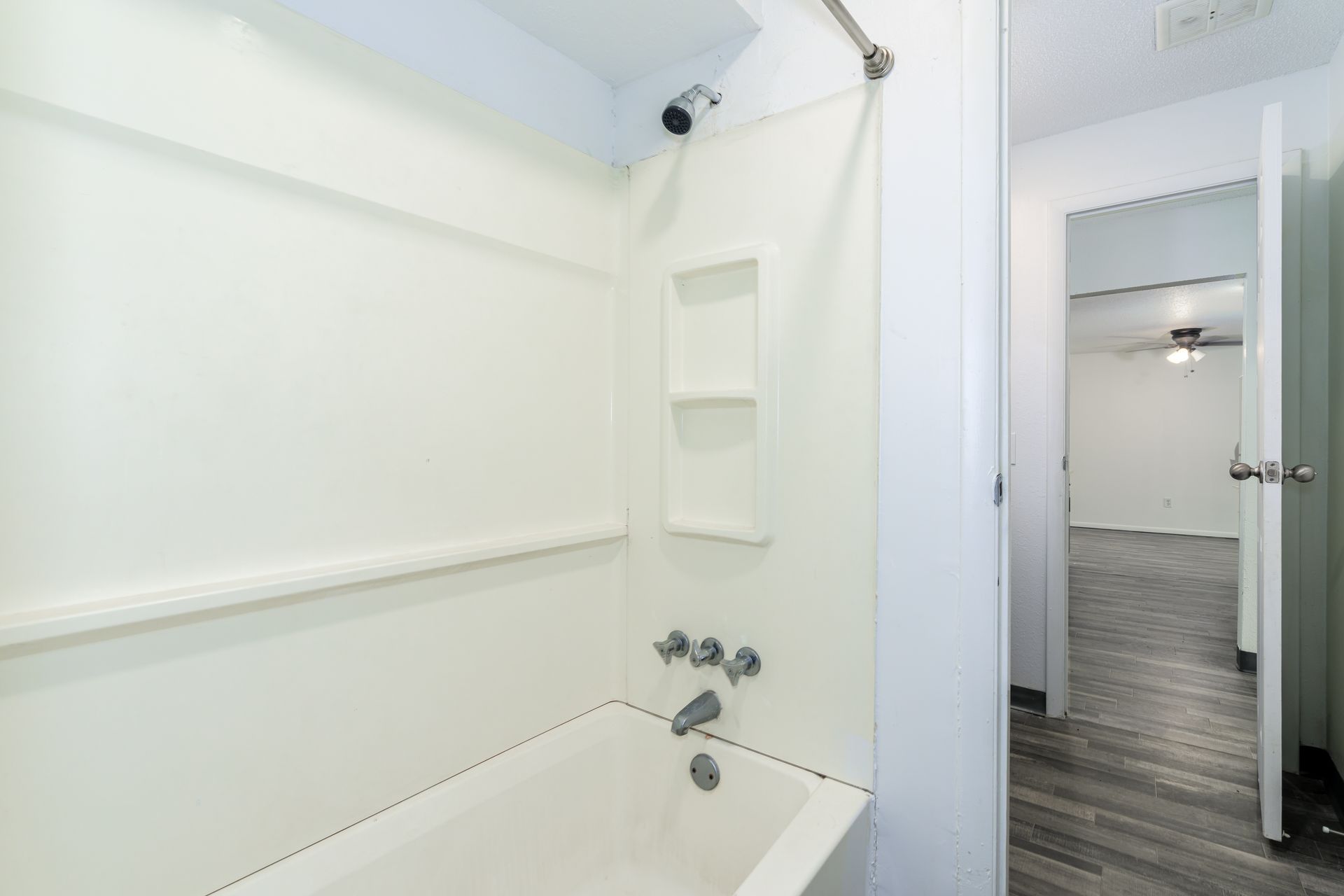 A bathroom with a bathtub and a shower.