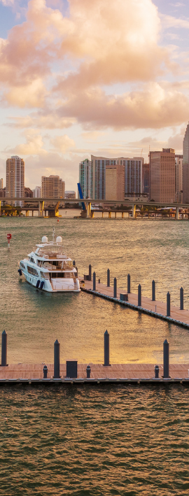 Modern living room with neutral colors, fireplace, large windows, and open staircase.