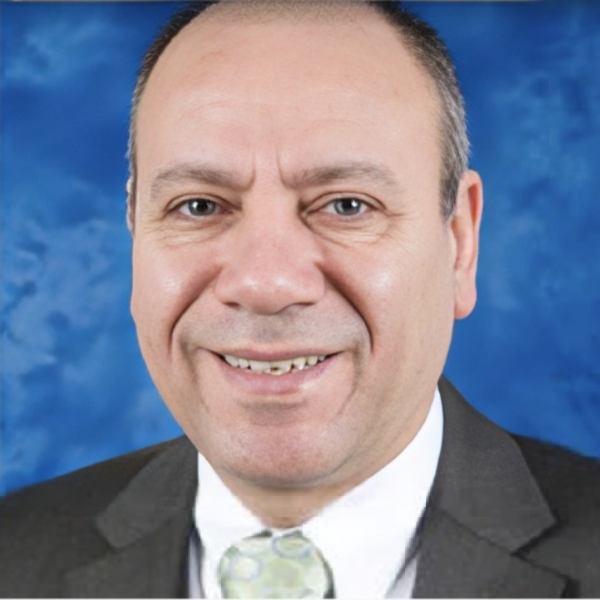 A man in a suit and tie smiles for the camera
