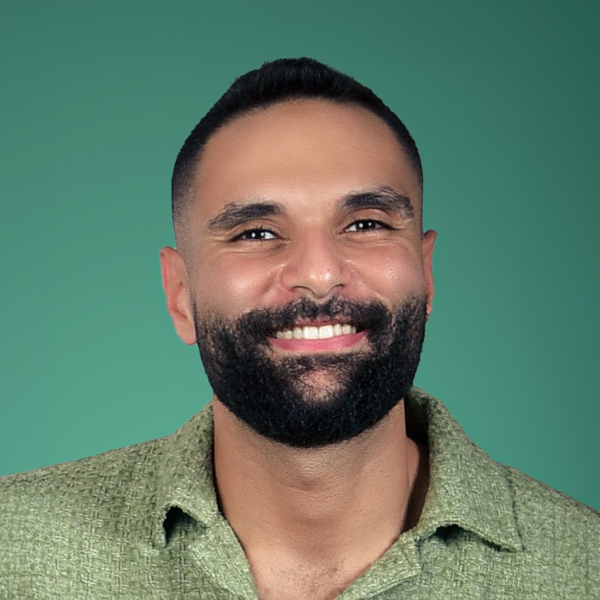 A man in a suit and tie smiles for the camera