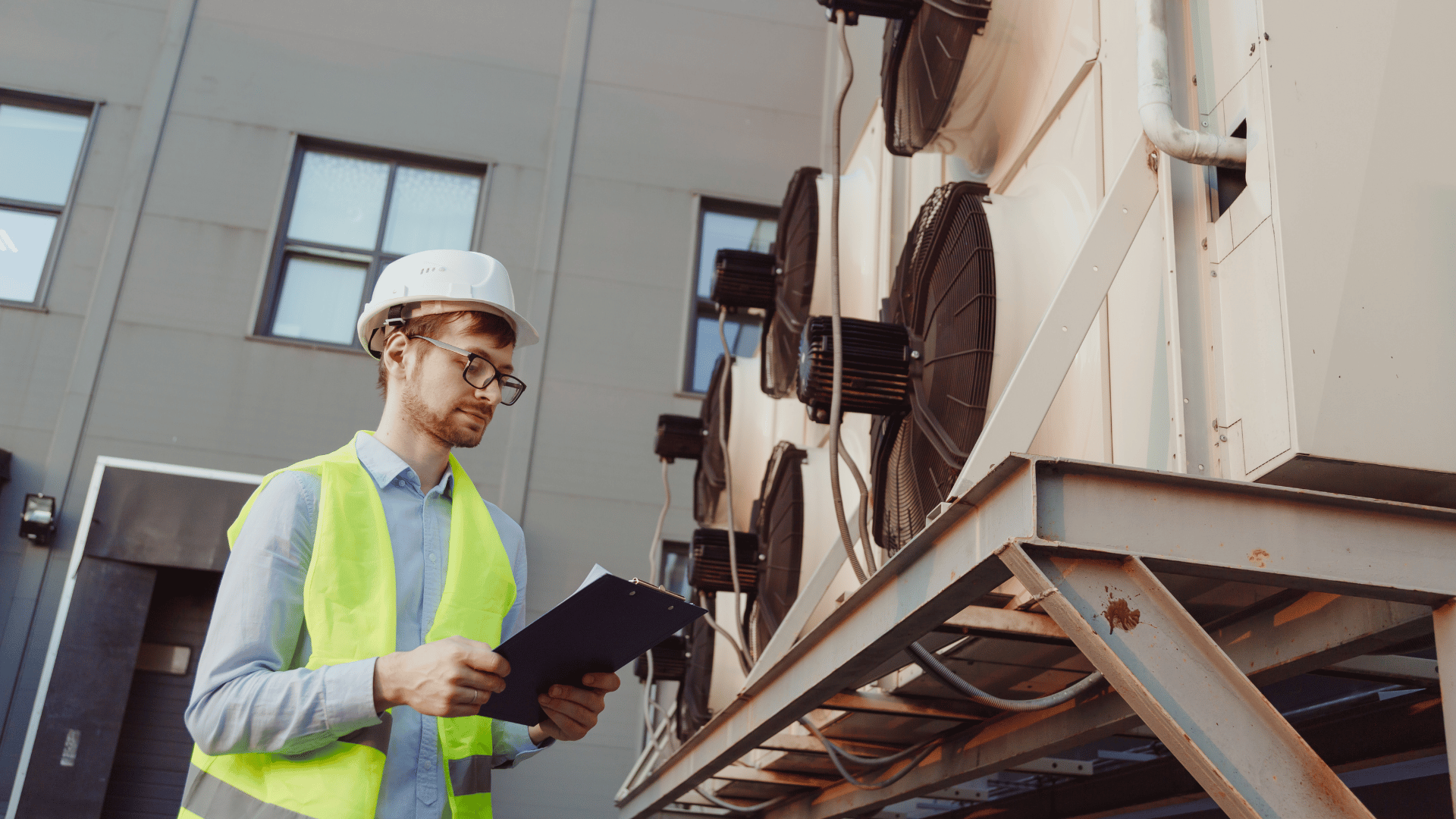 American Air Services, LLC - HVAC technician performing rooftop HVAC installation inspection with clipboard