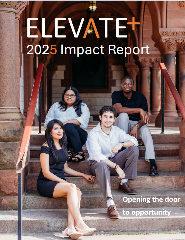 A group of people are standing in front of a white wall.
