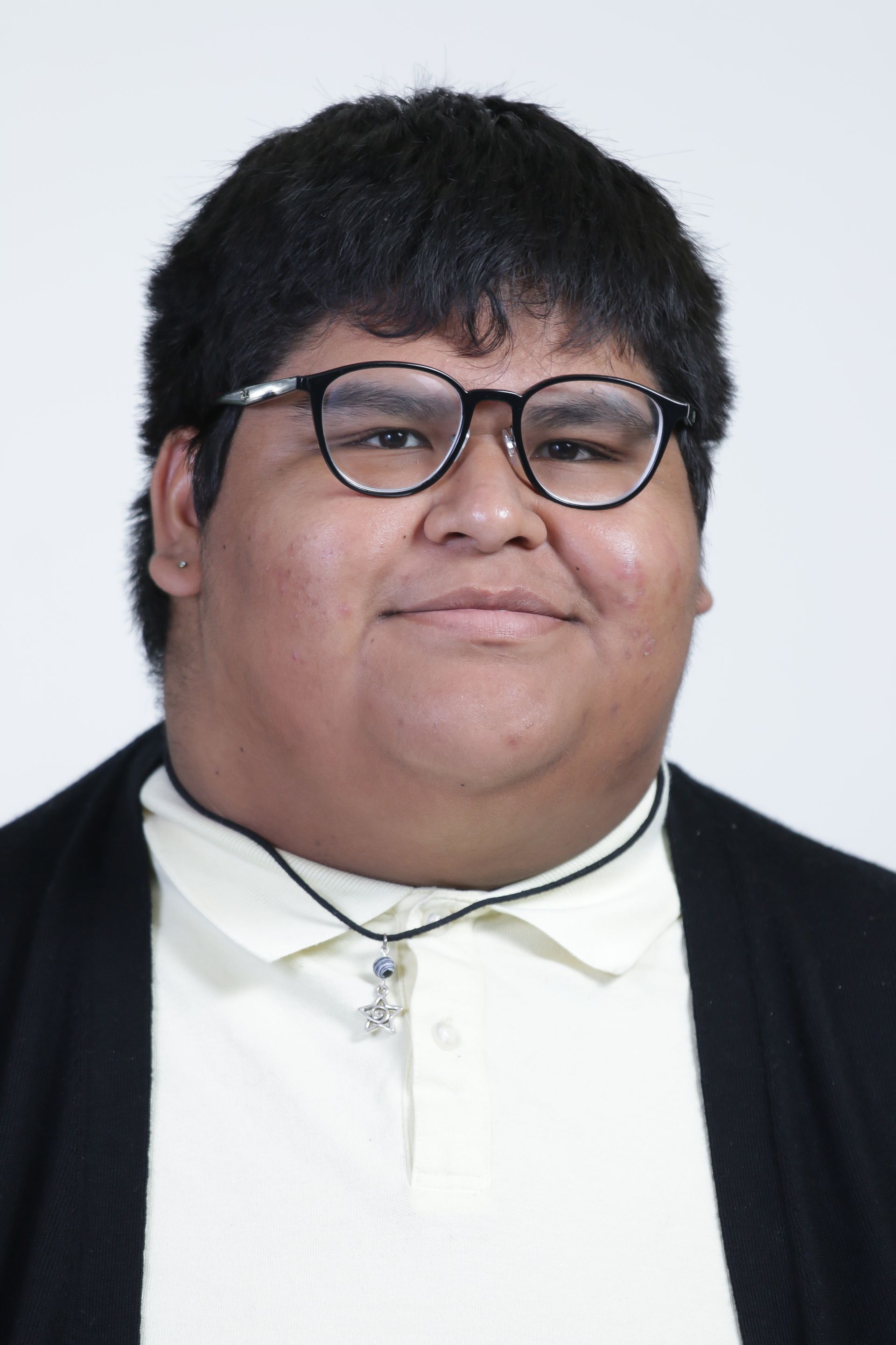 A man wearing glasses and a white shirt is smiling for the camera.