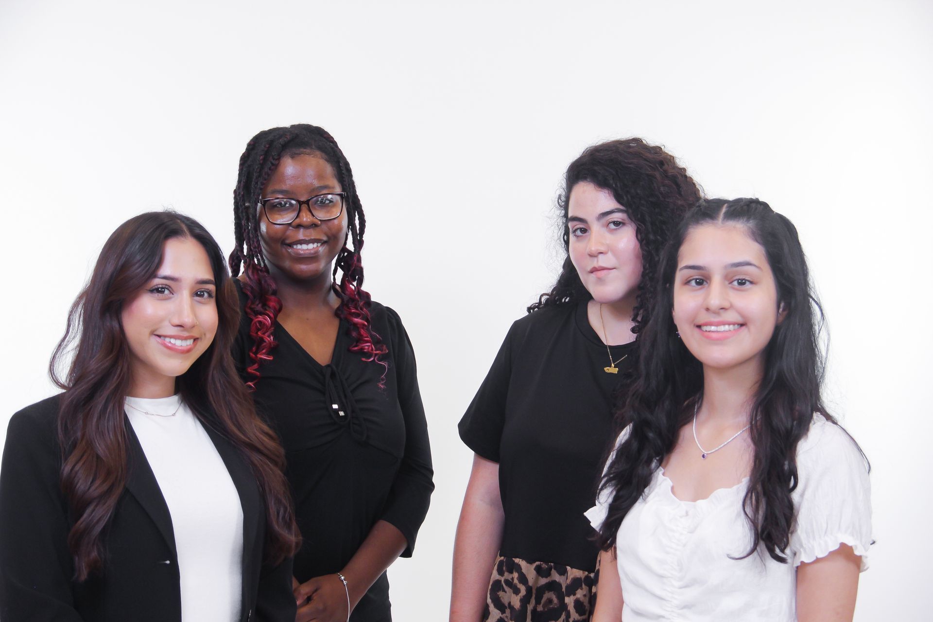 A group of young women are posing for a picture together.