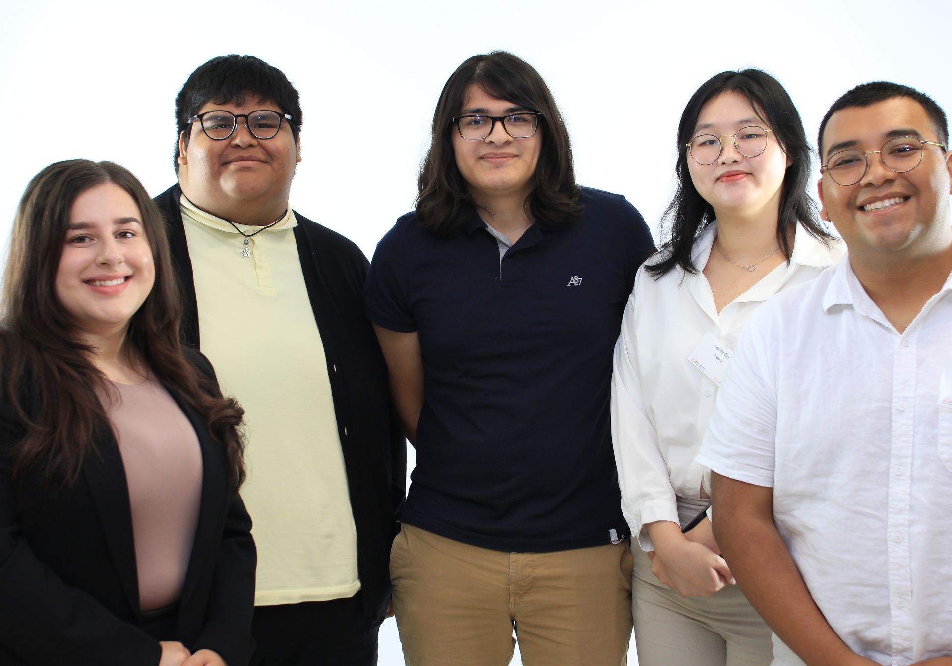 A group of young people are posing for a picture together.