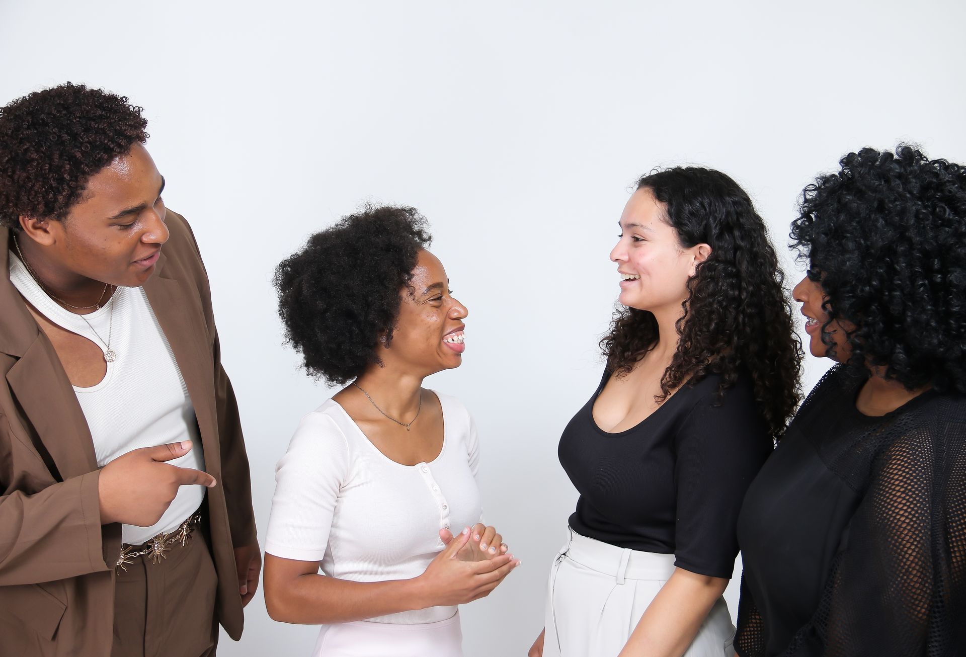 A group of people are standing next to each other and talking.