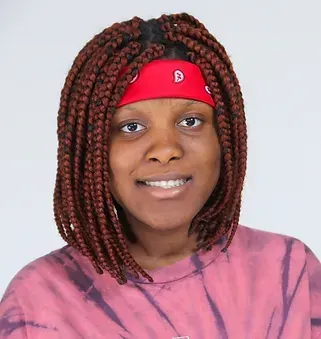 A woman with braids and a red bandana on her head