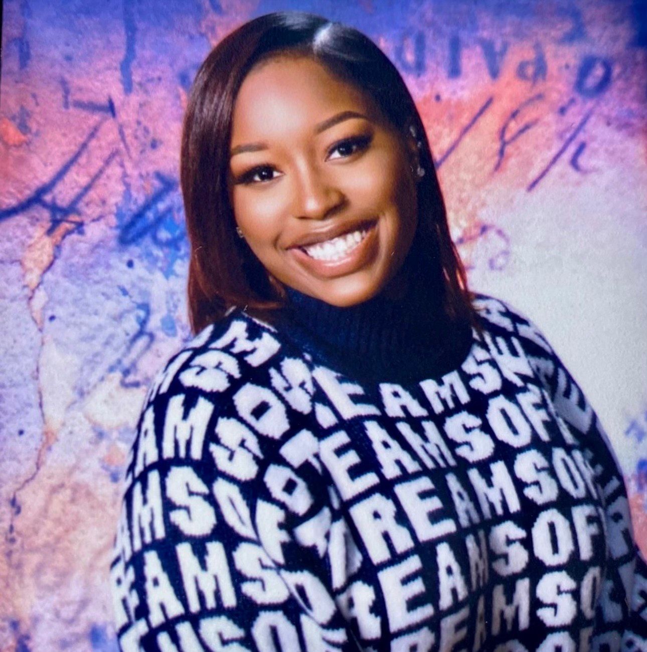 A woman wearing a sweater that says ams on it