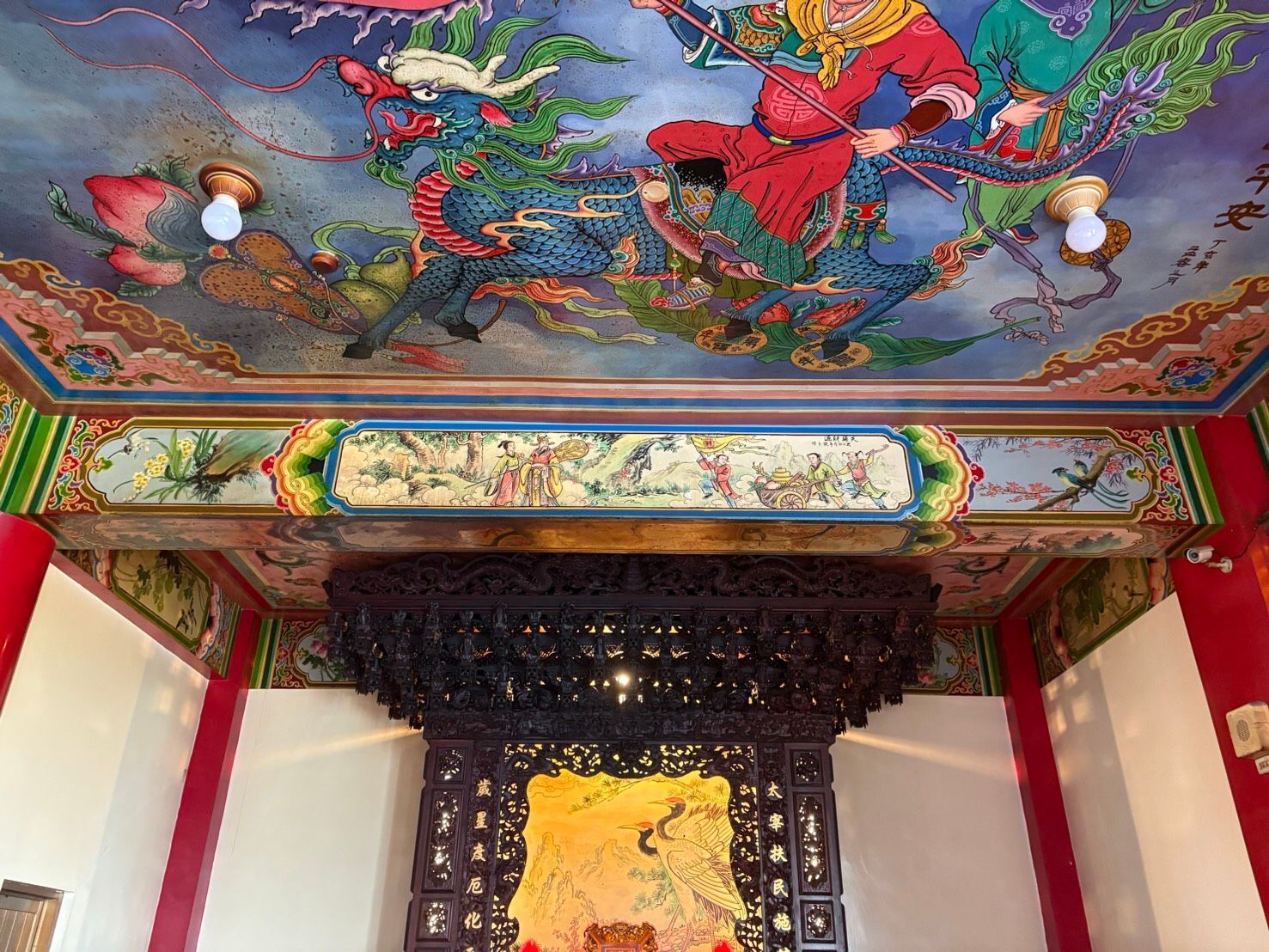 寺廟內部裝潢華麗,色彩斑斕,設有雕花木製祭壇和繪有鳥語花香的天花板。