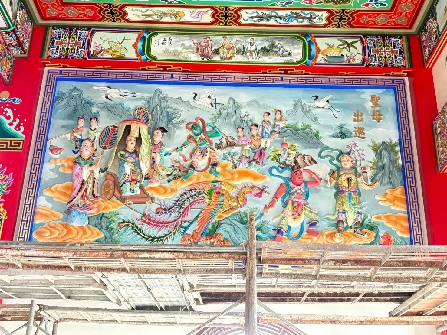 鮮豔的寺廟壁畫,描繪了印度教神靈和舞者,位於鮮紅色的天花板上。