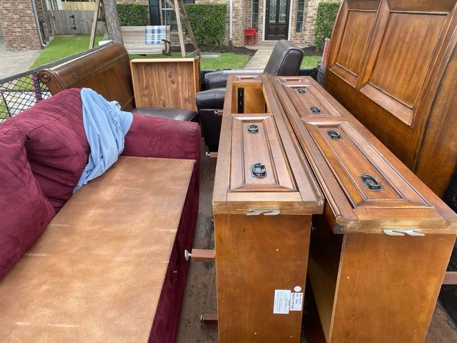A Bunch Of Furniture Is Sitting On The Ground In Front Of A House - Houston, TX - RoadRunner Junk Removal