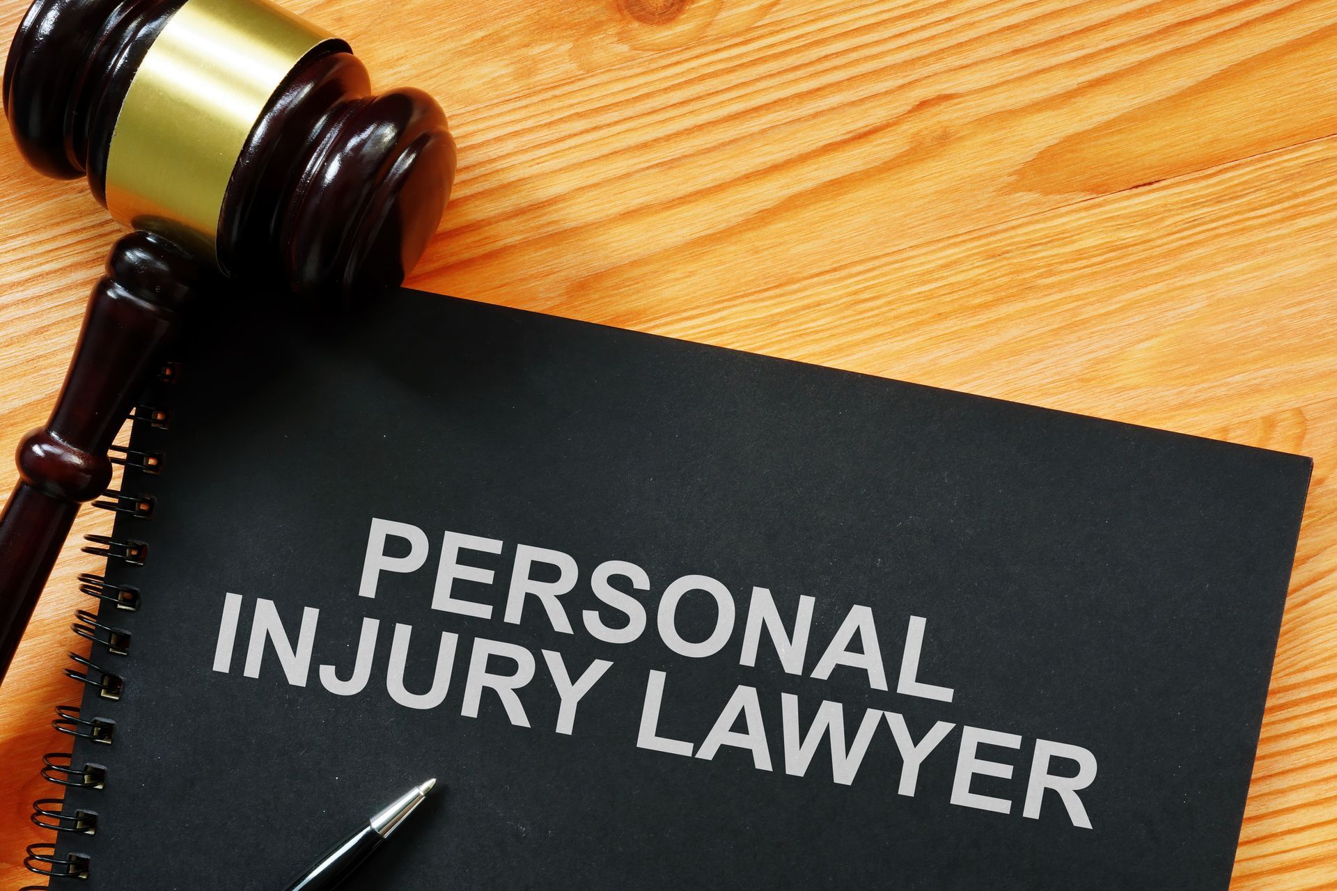 A personal injury lawyer book is on a wooden table
