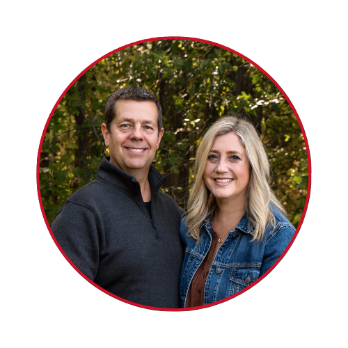 A man and a woman are standing next to each other in a circle.
