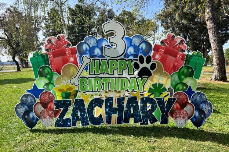 Birthday yard card in red, yellow, blue, and green. Puppy theme. 