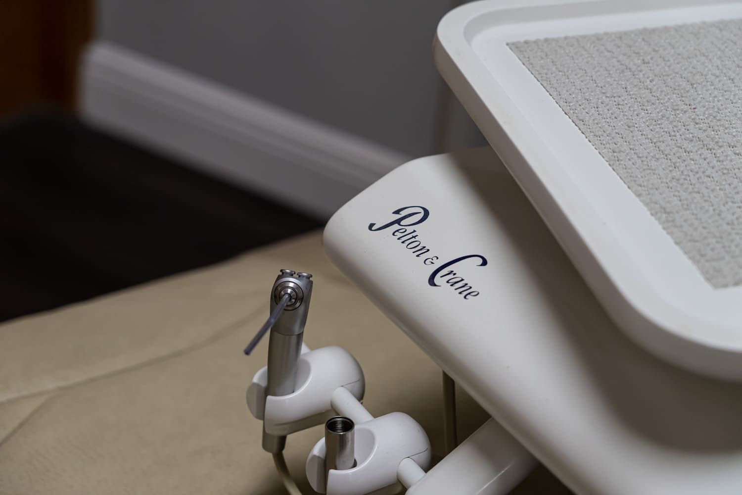 A dental chair with a dental drill attached to it