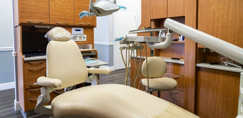 A dental office with a dental chair and dental equipment.
