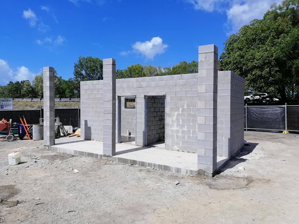 A Group of Construction Workers Are Working on A Building — Semrau Constructions In Bentley Park, QLD
