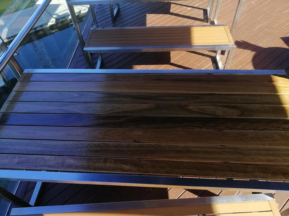 A Wooden Table with A Metal Frame on A Deck — Semrau Constructions In Bentley Park, QLD
