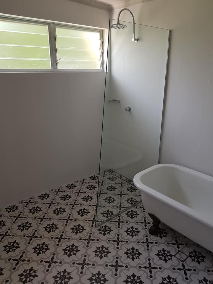 A Bathroom with A Bathtub, Shower, and Window — Semrau Constructions In Bentley Park, QLD