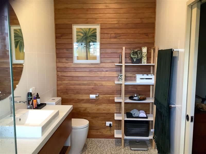 A Bathroom with A Wooden Wall and A Sink — Semrau Constructions In Bentley Park, QLD