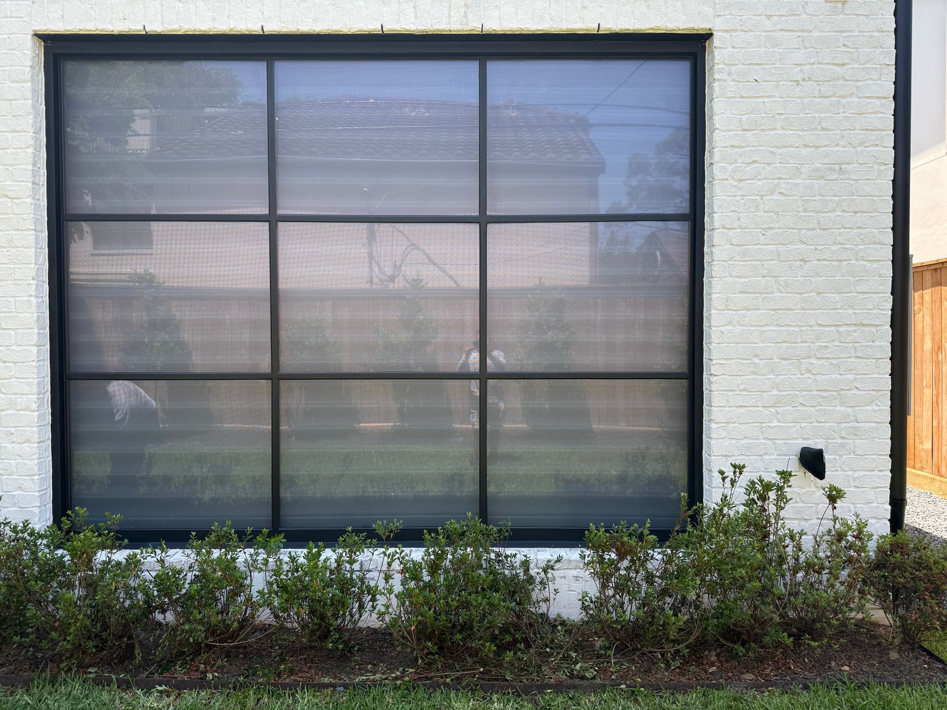 A red exit sign hangs above a glass door