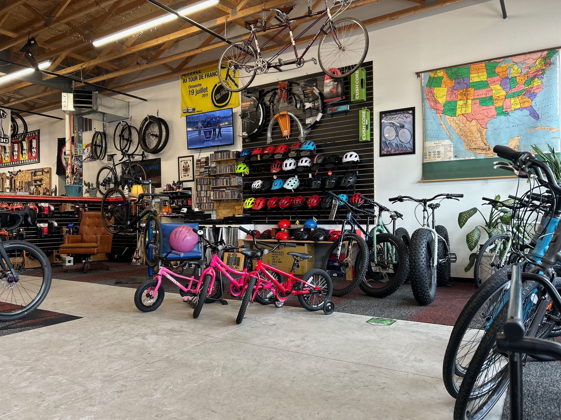 A bicycle shop filled with lots of bicycles and a map of the united states.