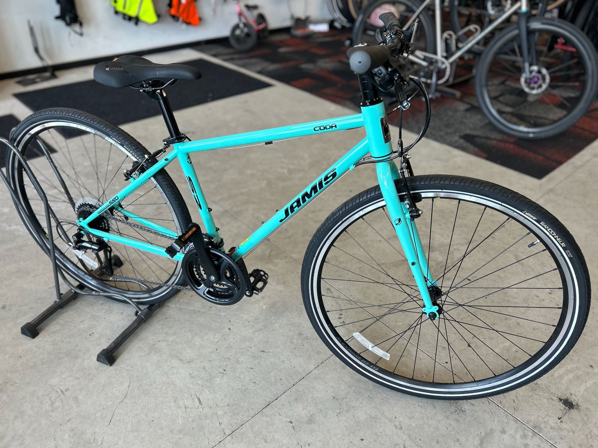 A turquoise bicycle is on display in a store