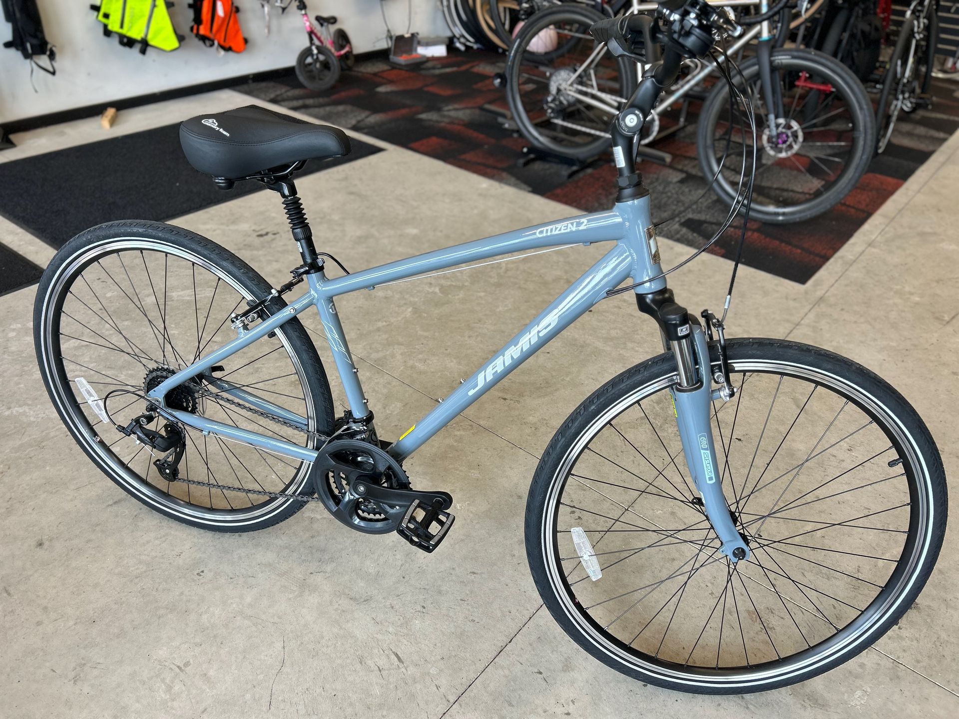 A bicycle is sitting on the floor in a store.