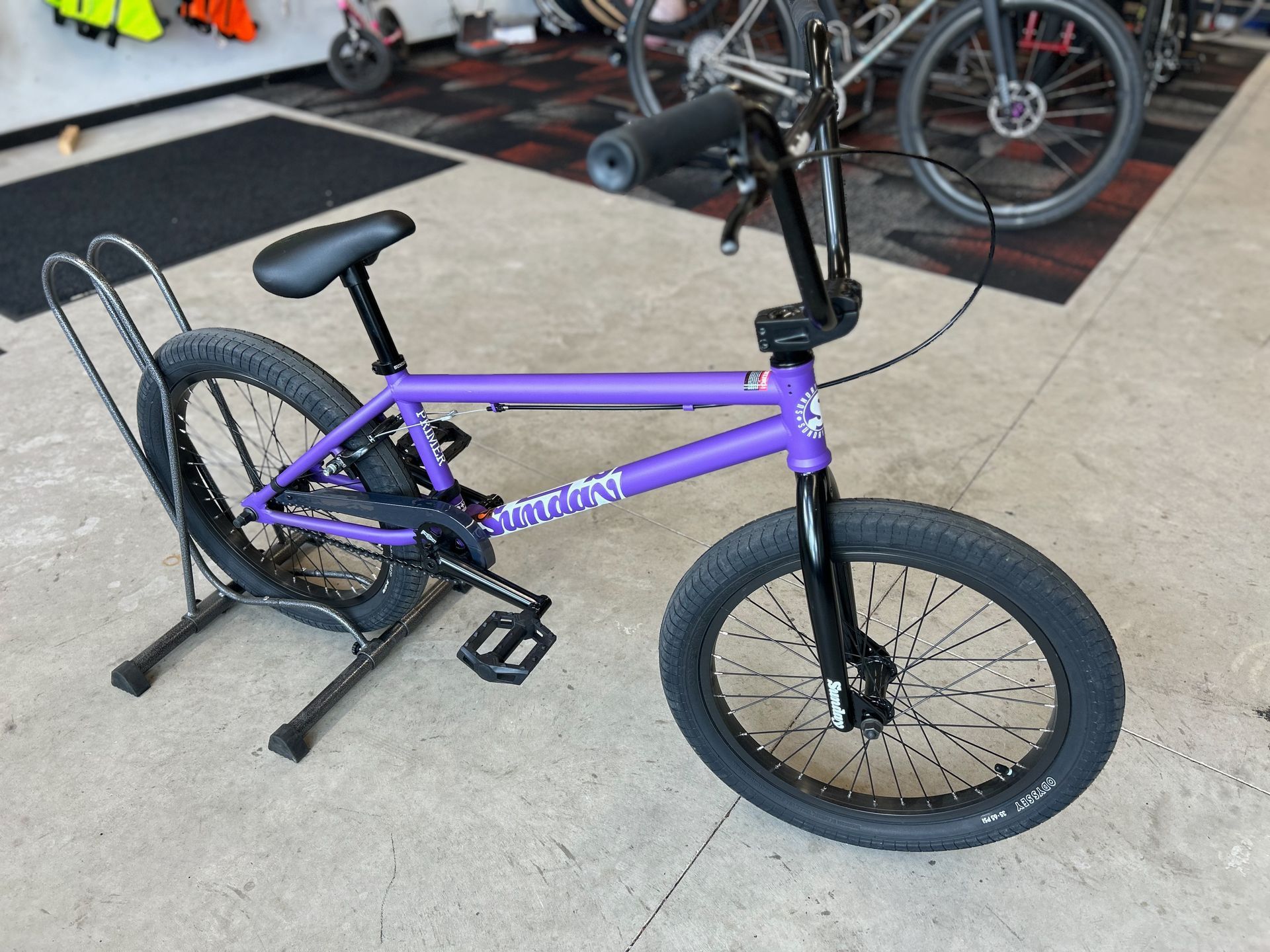 A purple bmx bike is on display in a store