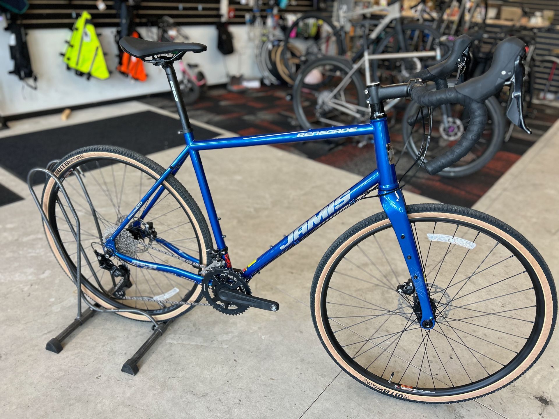 A blue bicycle is sitting on a stand in a store