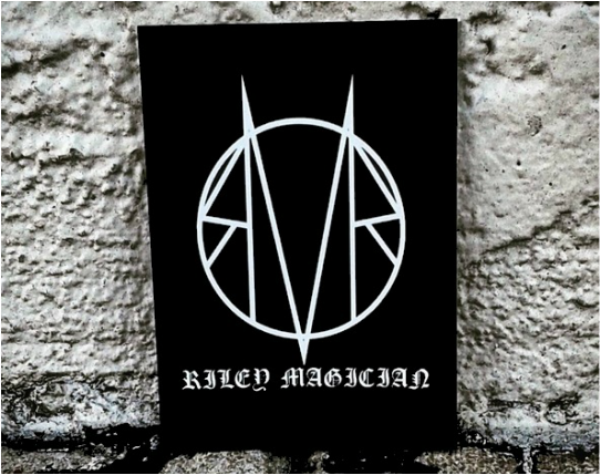 A black sign that says rated magician on it