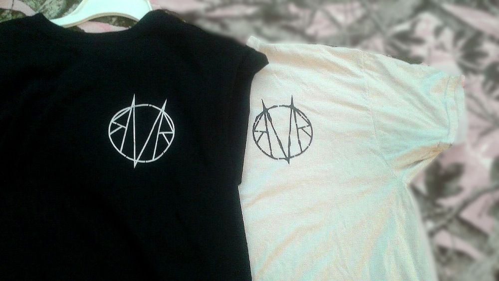 A black and white t-shirt with a symbol on it