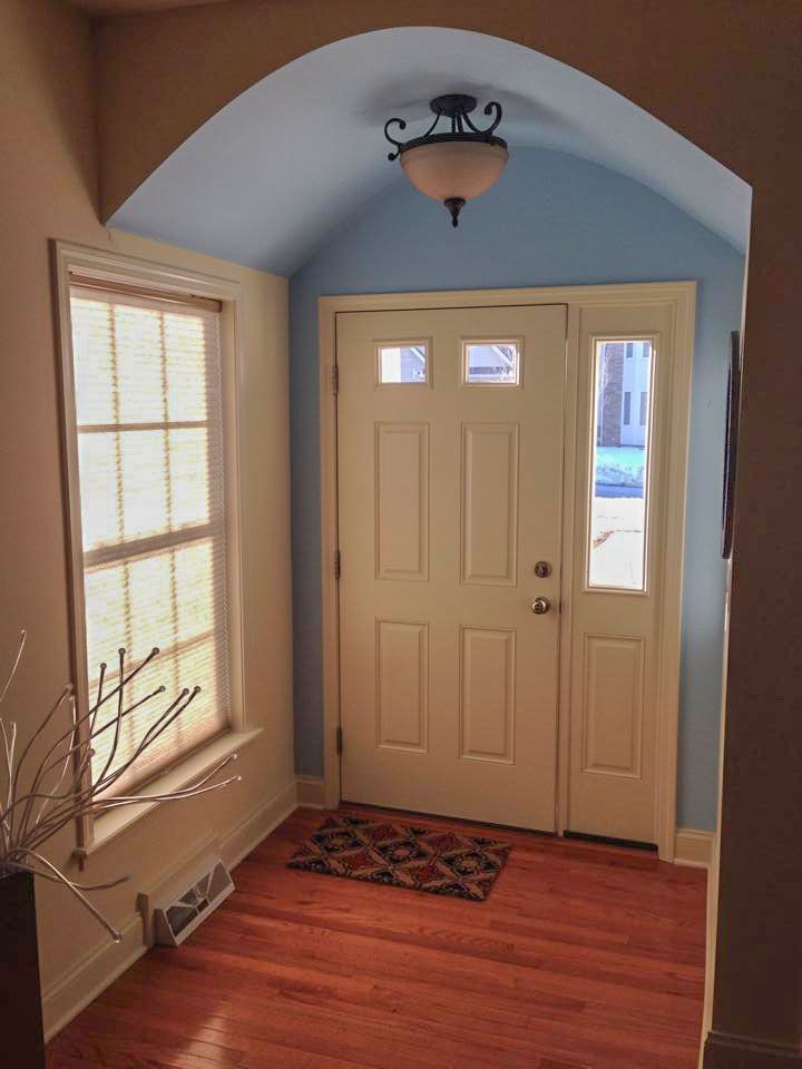 An aerial view of a living room with a fireplace and a ceiling fan.