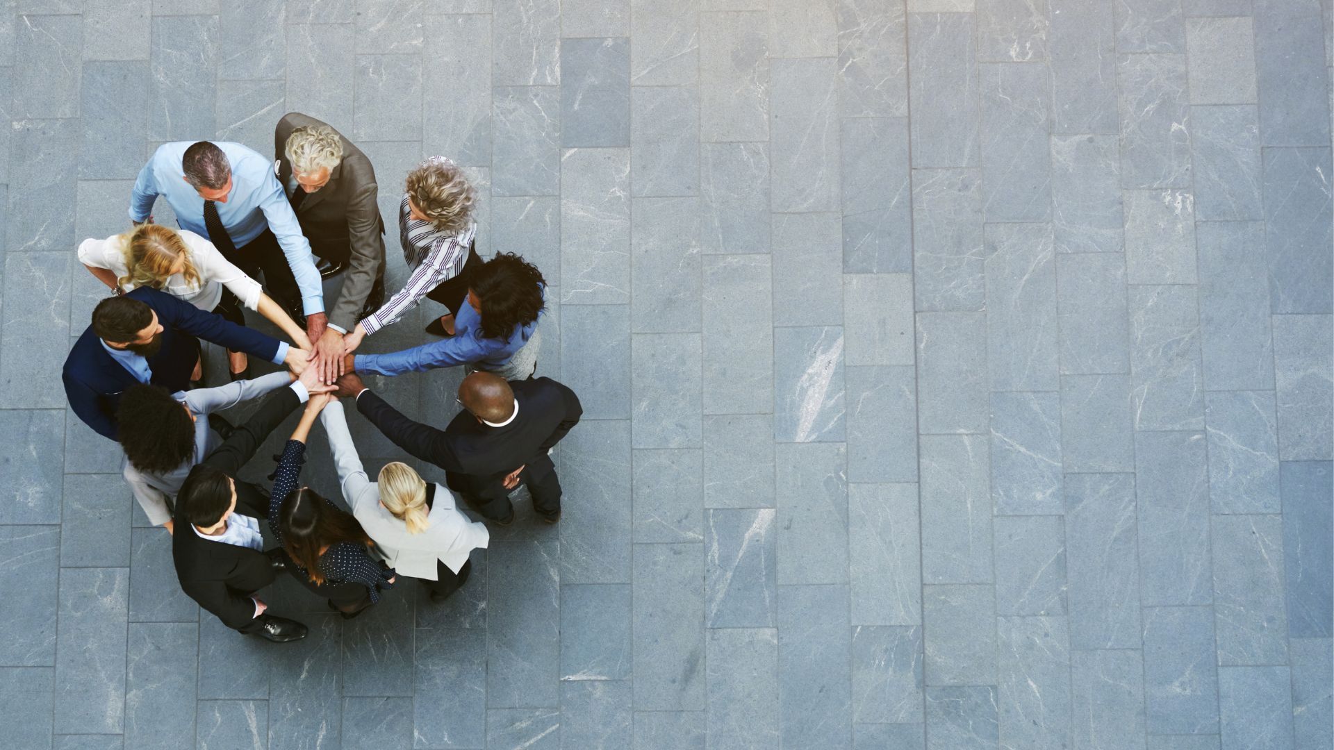 A group of people are sitting on a balcony in an office building.